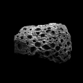 Unique Natural Porous Stone Featuring Irregular Holes On Black Background