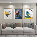 Modern Living Room With Three Abstract Paintings On Wall And Comfortable Sofa