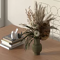 Dried Flowers in Green Vase on Wooden Table with Books and White Bird Figurines
