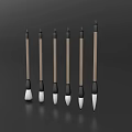 Six Wooden Handle Writing Brushes with Various Tip Shapes on Dark Background