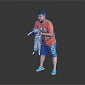 A man holding a cat in orange T-shirt and blue shorts against black background
