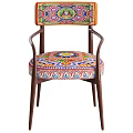 Vibrant Accent Chair With Colorful Patterned Seat Wooden Armrests And Green Throw Blanket