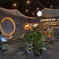 JOHOBUS Bar Restaurant Interior With Lush Plants Circular Decoration Lighting And Pebble Floor