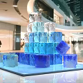 Art Installation Made of Stacked Ice Blocks in Modern Mall with Pedestrians Around