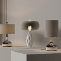 Three Contemporary Table Lamps with Cylindrical Round Shades and Illuminated Geometric Base on White