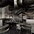 Modern Café Interior With Spiral Black Chandeliers Curved Seating Tables Chairs And Staircase