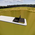 Black Kitchen Sink with Drainboard on White Countertop in Outdoor Grassy Setting