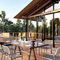 Traditional Guesthouse Architecture With Courtyard Stone Pathways Outdoor Seating And Greenery