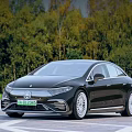 Luxury Black Mercedes-Benz Electric Sedan With Sleek Exterior Design And Green Forest