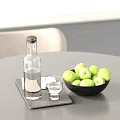 Green Apples In Black Bowl With Clear Glass Bottle And Cup On White Table Trays