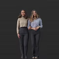 Two Women Wearing Beige Sweater And Light Blue Shirt With Dark Pants On Dark Background