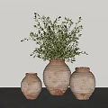 Potted Green Plant in Terracotta Pot with Two Smaller Pots on Gray Surface