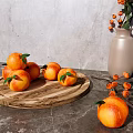 Fresh Oranges on Wooden Tray with Gray Countertop and Vase with Orange Berries