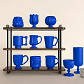 Collection of Blue Mugs with Various Designs Arranged on a Wooden Shelf