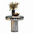 Modern Round Side Table With Black White Striped Base Vase Bowl And Books