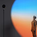 Black Modern Floor Lamp with Sculpture and Blue Orange Gradient Light in Artistic Interior