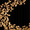 Golden Chandelier with Small Crystal Beads Arranged in Moon Shaped Design Against Black Background