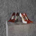Fashionable Red And White High Heels With Sparkling Details On Gray Stone Pedestal
