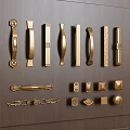Various Gold Cabinet Handles In Different Styles Displayed On Dark Wood Panel