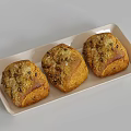 Three Fresh Golden Bread Loaves on White Tray With Crunchy Toppings