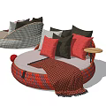 Round Single Seater Sofa With Red Black Woven Design Gray Cushion Pillows And Throw Blanket