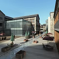 Modern Traditional Commercial Street With Glass Facade Stone Buildings Outdoor Seating And Pedestrian Areas