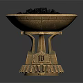 Golden Decorative Bowl With Intricate Base Holding Black Granules And Small Gear