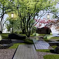 Natural Rockery Stones Landscape With Trees Hanging Lanterns Stone Slab Pathway And Rustic Cabin