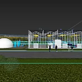 Industrial Factory Building with Glass Facade in Green Outdoor Area Under Blue Sky and Clouds