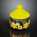 Decorative Glass Storage Jar With Yellow Lid And Colorful Flower Patterns