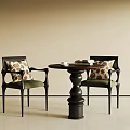 Modern Dining Table Set With Round Top Black Base Two Chairs Green Cushions Patterned Pillows