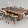 Wooden Dining Table Set With Woven Back Chairs Blue Cushions Vase And White Flowers