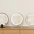 Round Lighted Mirrors With Black Silver Gold Bases On Wooden Surface