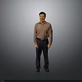 The Man Standing Against Gray Background In Pink Shirt Dark Pants And Black Shoes