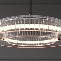 Modern Transparent Glass Circular Chandelier With Warm LED Lighting Against Gray Wall Background
