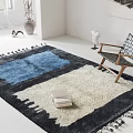 Leisure Chair with Woven Seat Wooden Frame Blue White Tasseled Rug and Stack of Books