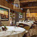 Elegant Private Dining Room With Wooden Ceiling Cage Chandeliers Decorative Paintings And White Tablecloths