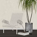 Modern Leisure Chair With Metal Frame And Woven Design By Potted Plant And Books