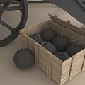 Black Cannon With Large Wheels In Room Next To Wooden Crate And Cannonball