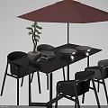Black Outdoor Table with Red Umbrella Potted Small Tree Books and Bowls