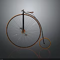 Vintage High Wheel Bicycle With Black And Orange Frame And Spoked Wheels