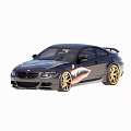 Black Two Door Coupe Car With Gold Wheels And Shark Mouth Graphic