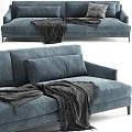 Modern Blue Two Seater Sofa With Gray Blanket And Decorative Cushions In Contemporary Design