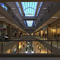 Shopping Mall Elevator Aisle With Glass Skylight Multiple Floors Escalators and Greenery