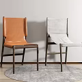 Orange Leather and Grey Fabric Chairs on Grey Rug against White Wall and Wooden Floor