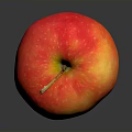 Fresh Ripe Red and Yellow Apple with Stem on Reflective Dark Surface