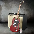 Red Electric Guitar Leaning On Black Beige Amplifier In Studio Setup