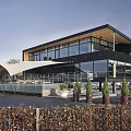 Modern Building Exterior With Large Glass Windows Black Walls And Terrace Red Lights Outdoor Seating