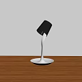 Modern Table Lamp with Black Shade White Curved Stem and White Base on Wooden Tabletop