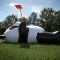 Giant Inflatable Panda Landscape Sculpture On Green Grassland With Red Flag Blue Sky And Trees
